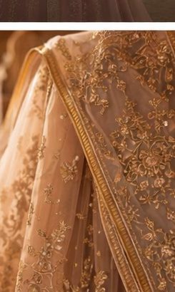 Zardozi gold thread embroidery on rich fabric close-up